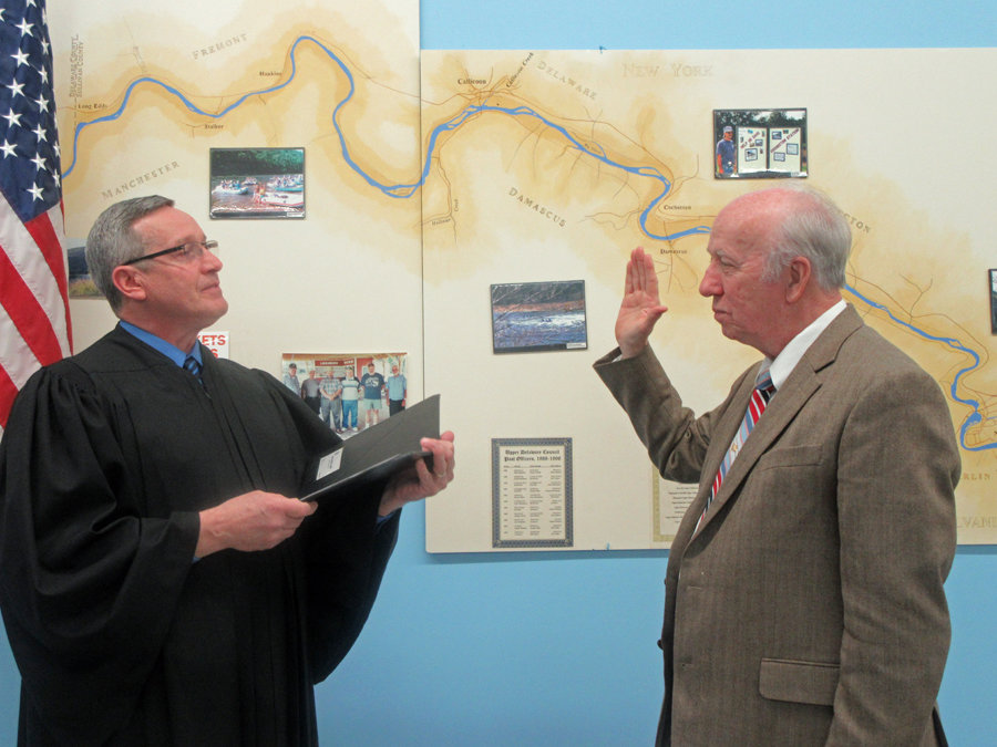 The Honorable Steven Sauer, Town of Cochecton Town Justice, left, swears in Larry H. Richardson as 2020 chairperson of the Upper Delaware Council.